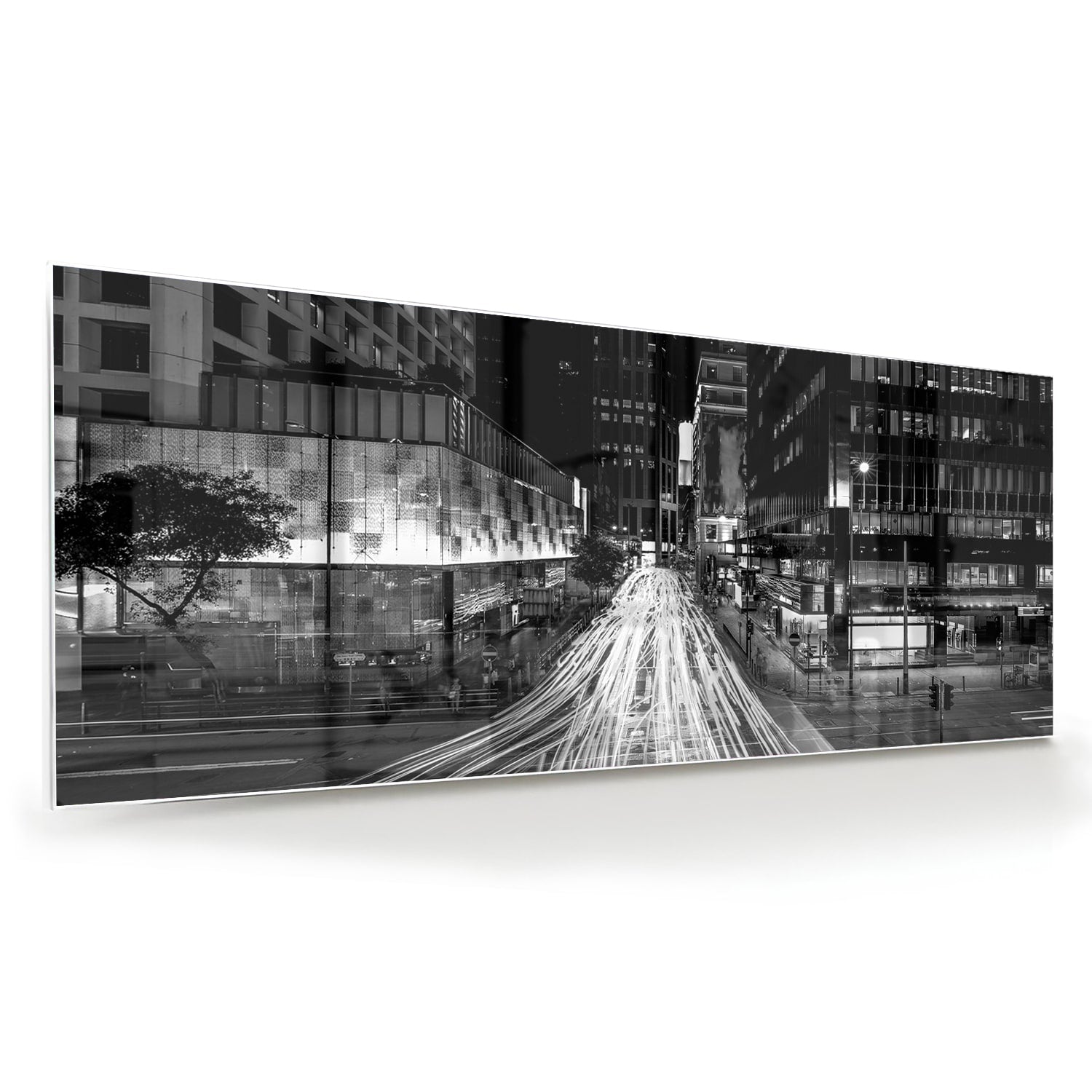 Glazen schilderij met stadslichten in zwart-wit boven een moderne meubelset.