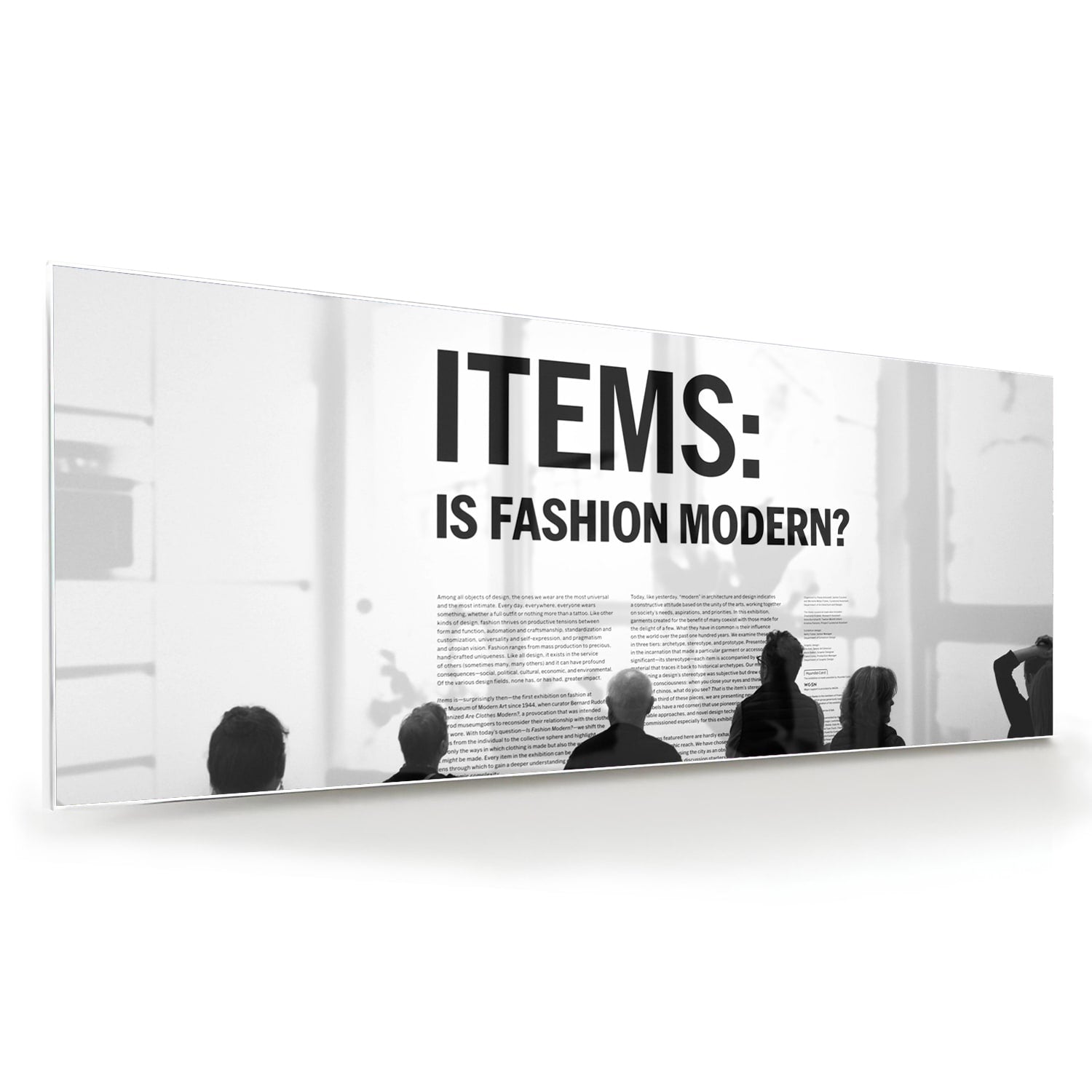 Glazen schilderij met de tekst 'ITEMS: IS FASHION MODERN?', stijlvol gepresenteerd boven een houten meubel.