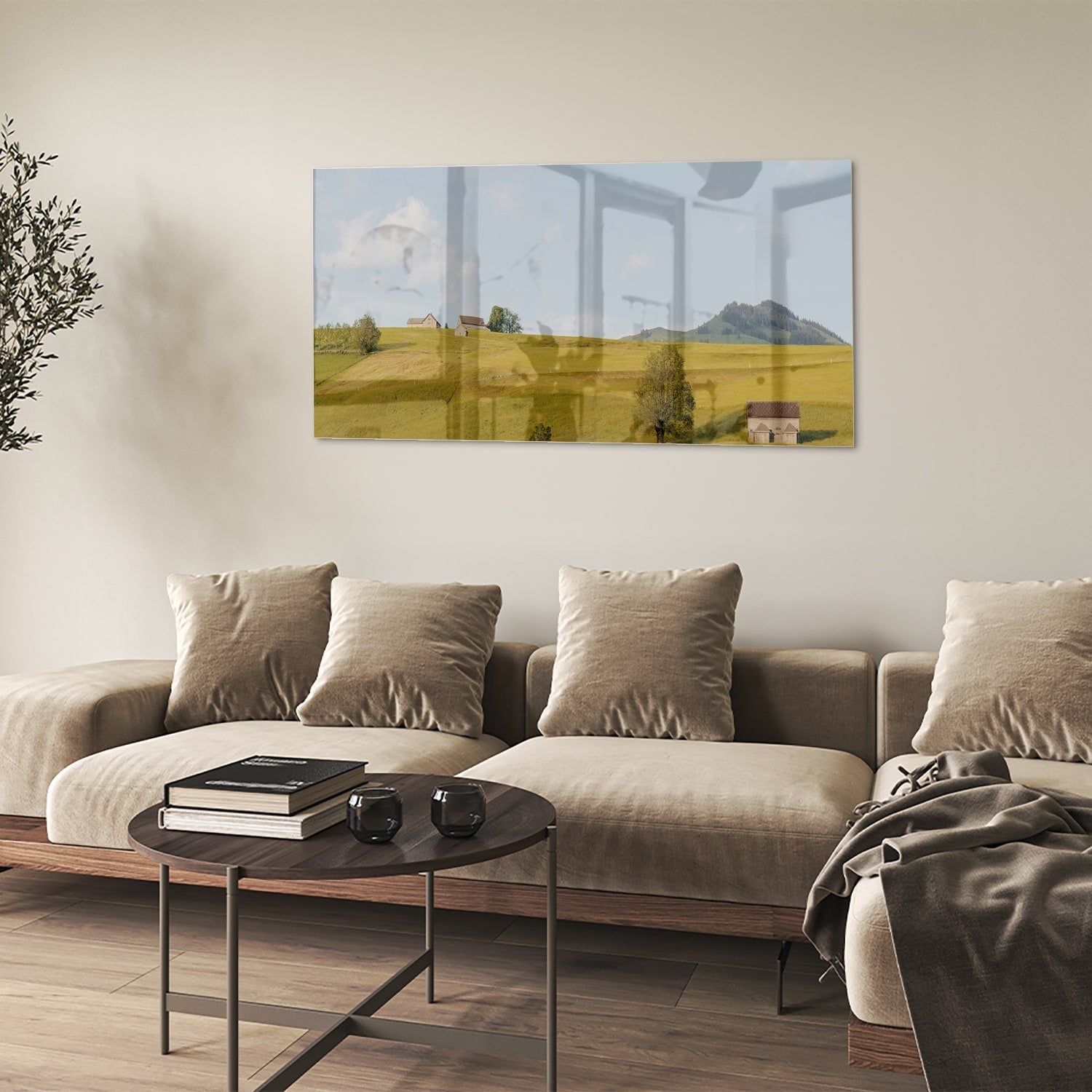 Glazen schilderij met groene heuvels en boerderijen op een witte muur.