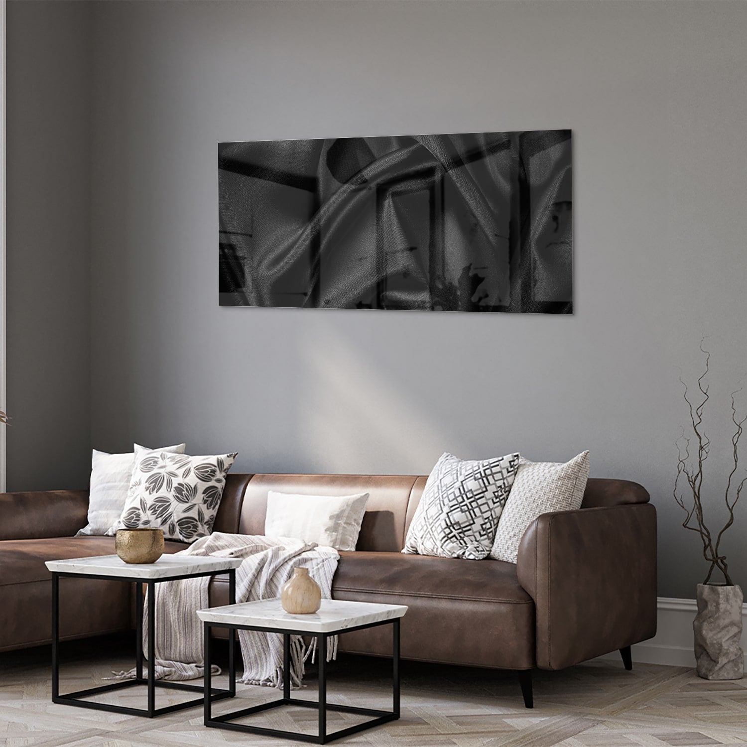 Een zwart glazen schilderij hangt aan de muur van een moderne woonkamer.