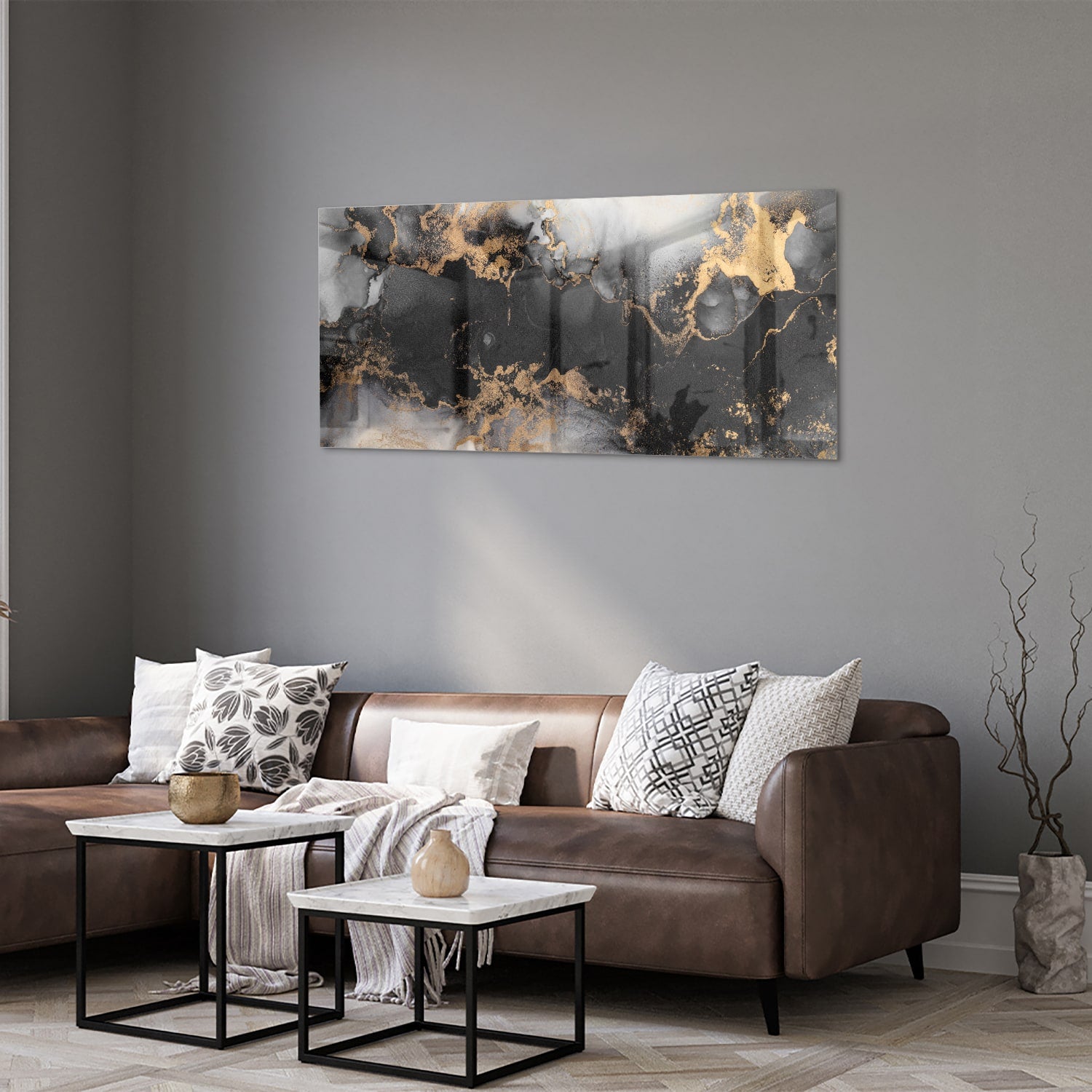 Glazen schilderij met zwarte en gouden abstracte patronen aan de muur boven een houten kast.