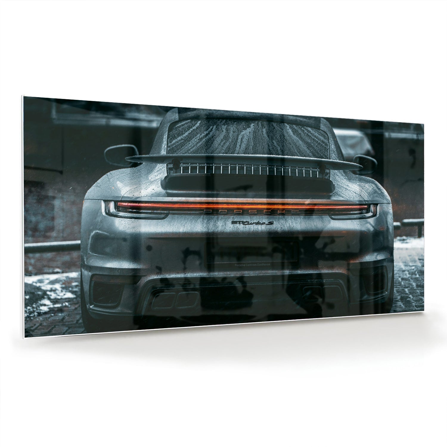 Glazen schilderij van een sportwagen aan de muur in een lichte woonkamer.