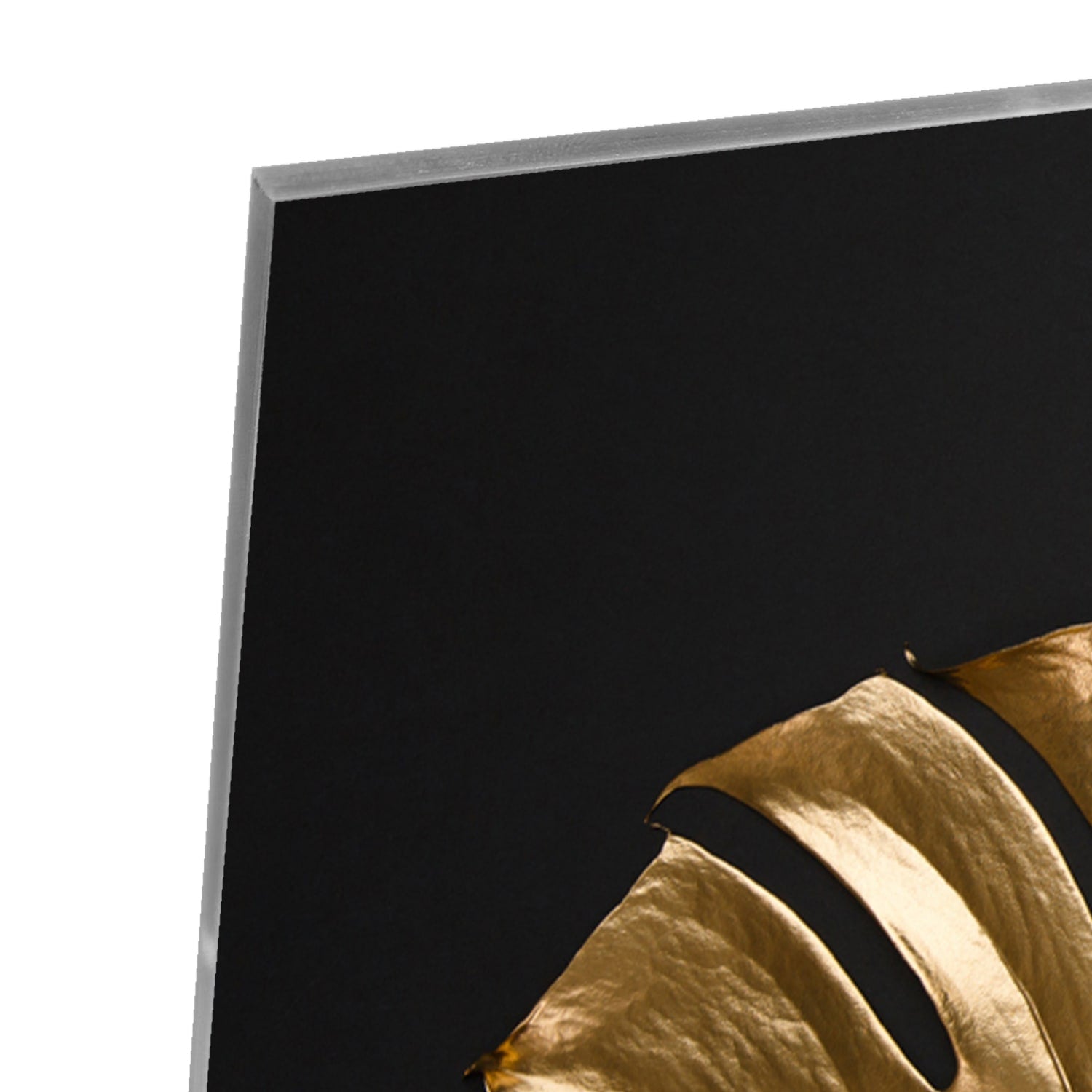 Gouden glazen schilderij met monstera bladeren aan de muur