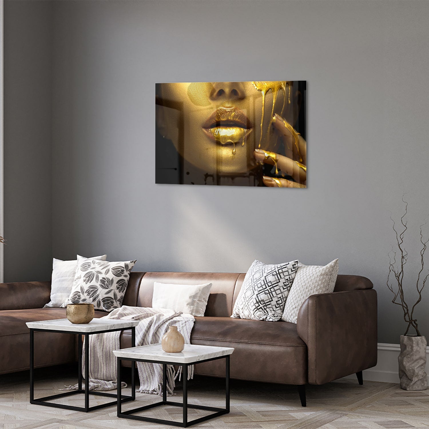 Gouden glazen schilderij van lippen met glanzende vloeistof op een muur.