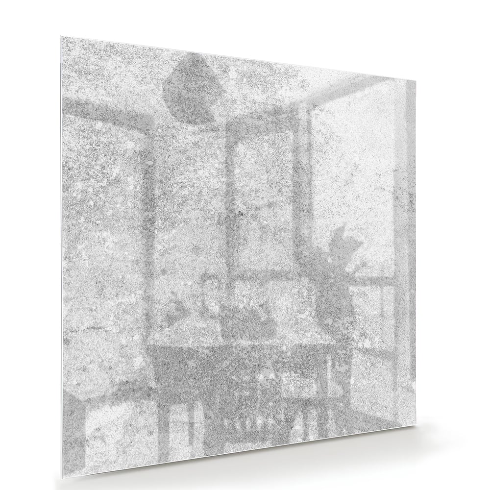 Abstract glazen schilderij met een subtiele textuur aan de muur in een moderne woonkamer.