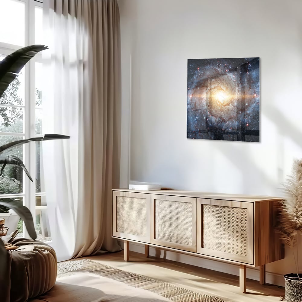 Glazen schilderij van een sterrenstelsel aan de muur in een lichte woonkamer.