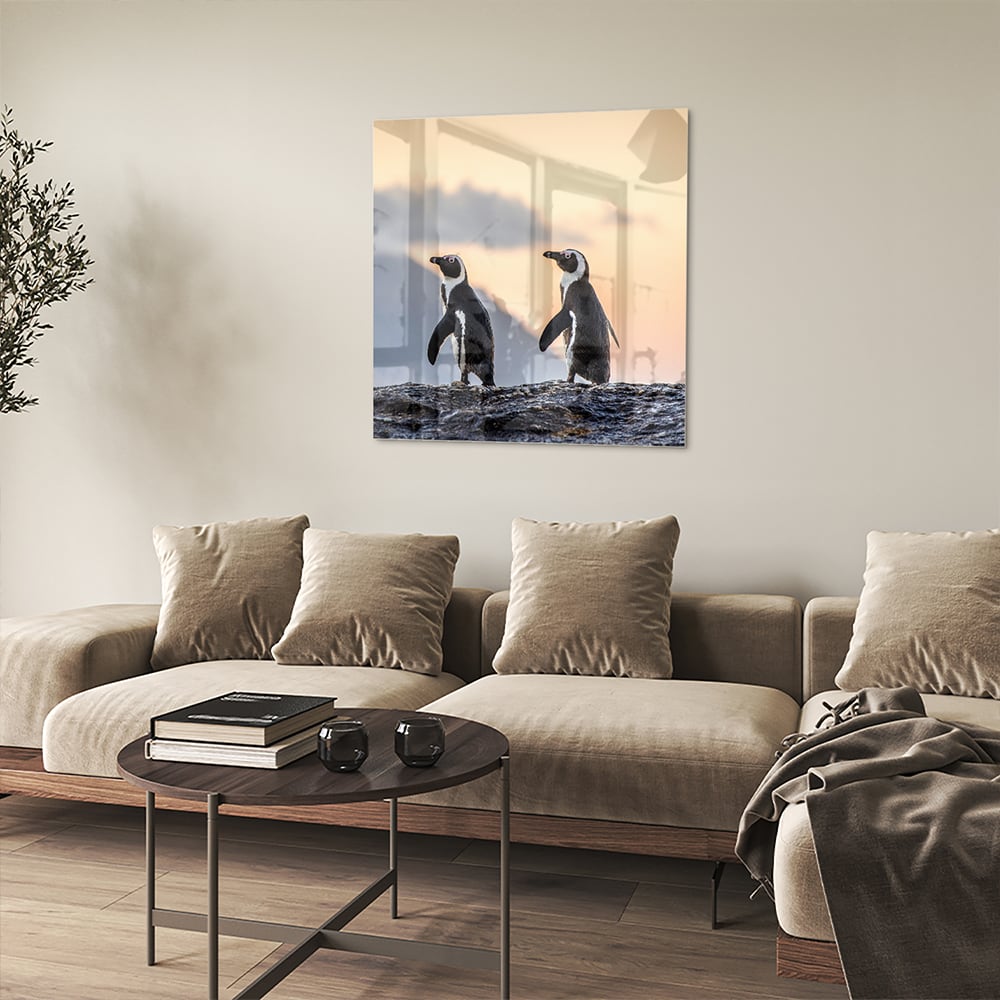 Glazen schilderij van pinguns aan zee met een zonsondergang op de achtergrond