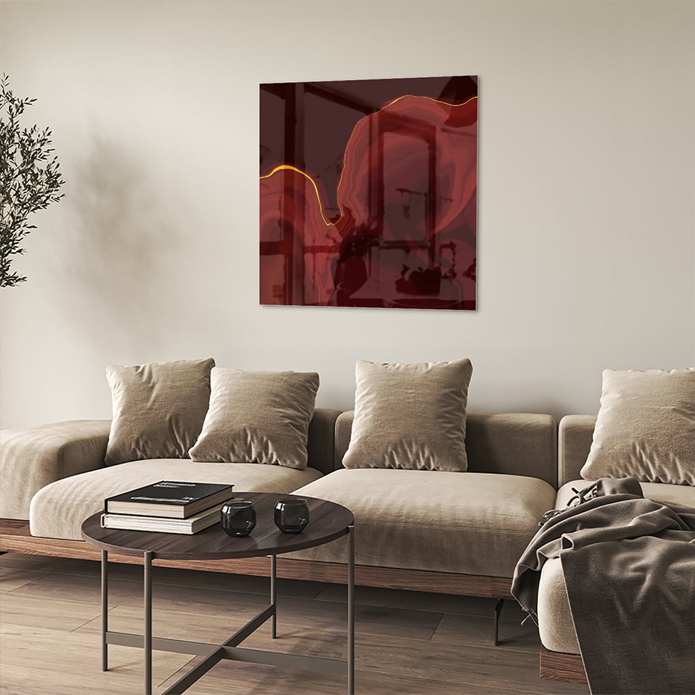 Abstract glazen schilderij met warme roodtinten aan de muur