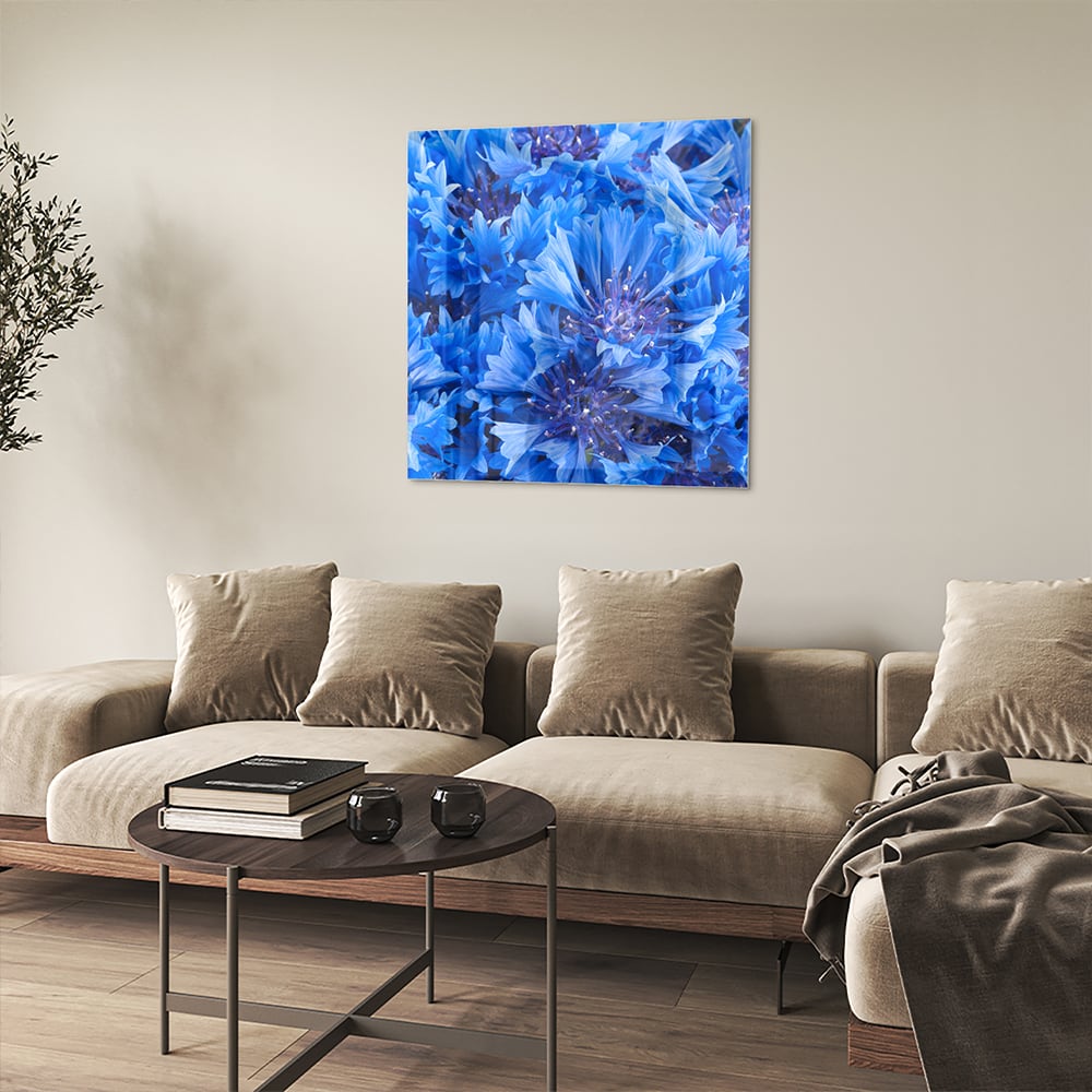 Glazen schilderij met een prachtig blauw bloemenmotief aan de muur