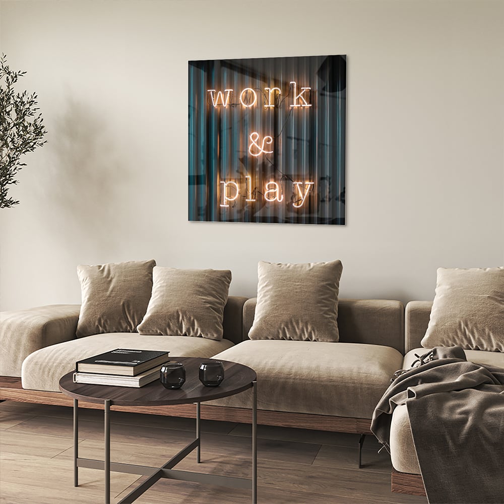 Glazen schilderij met de woorden 'Work & Play' in sfeervolle verlichting.
