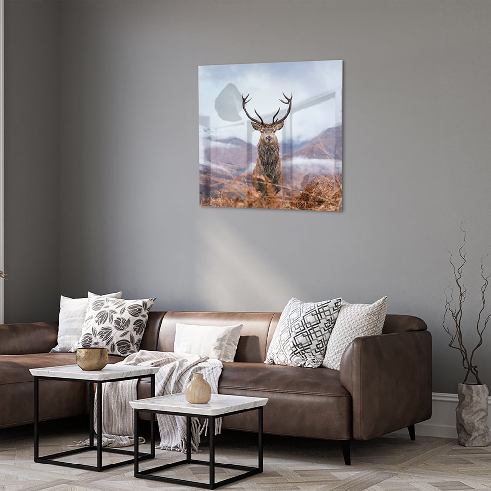 Glazen schilderij van een hert in een berglandschap met natuurlijke kleuren.