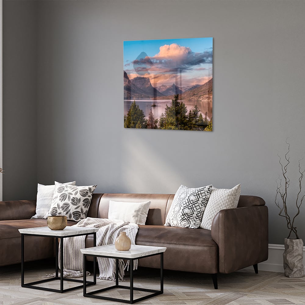 Glazen schilderij van bergen bij zonsopgang in een lichte woonkamer.