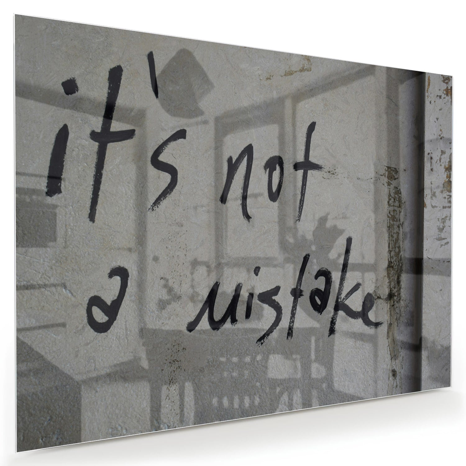 Glazen schilderij met de tekst 'it's not a mistake' aan de muur