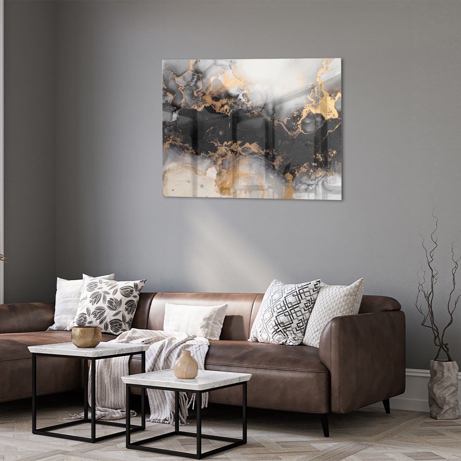 Glazen schilderij met zwarte en gouden abstracte patronen aan de muur boven een houten kast.