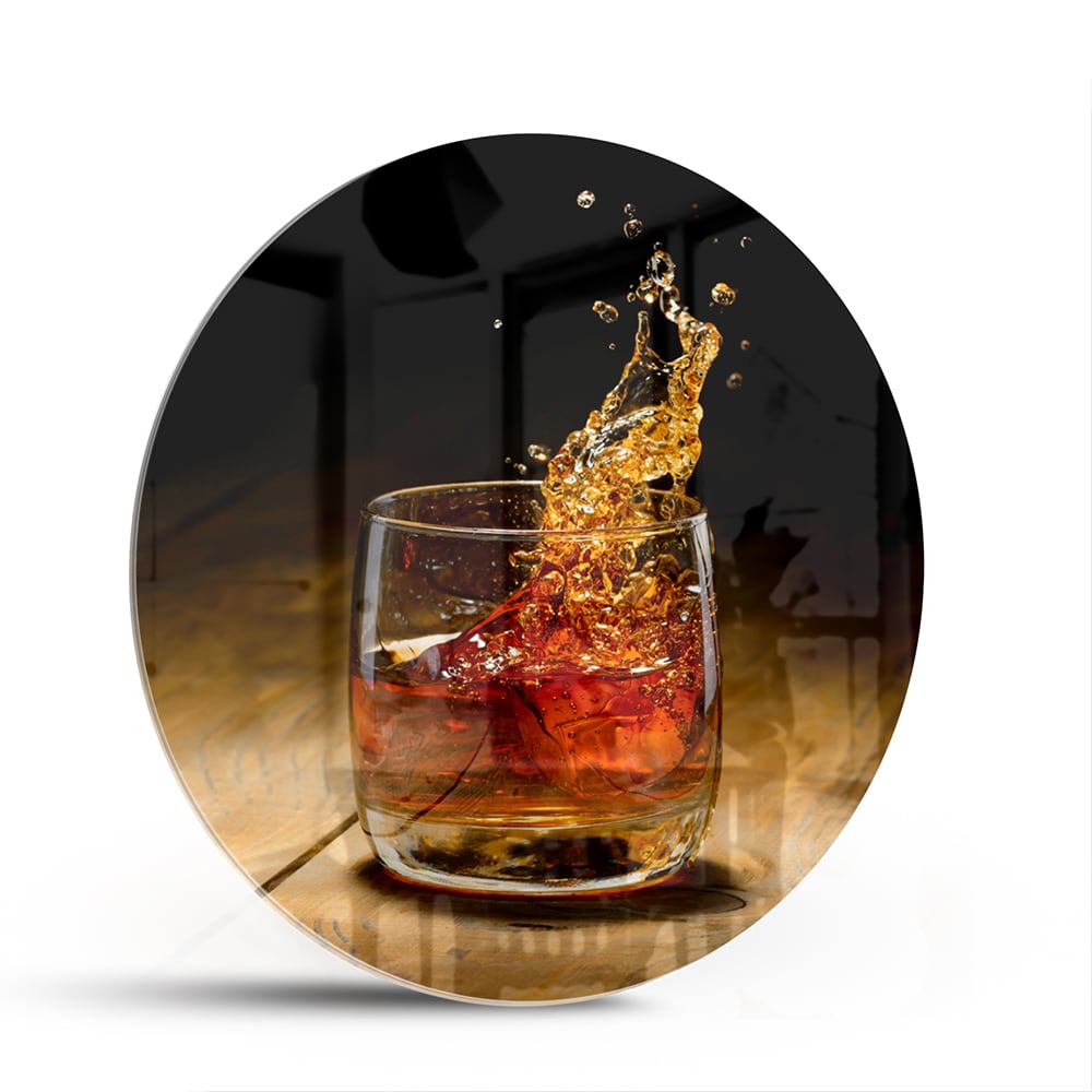 Glazen schilderij met een glas en spetterende drank op een houten tafel.