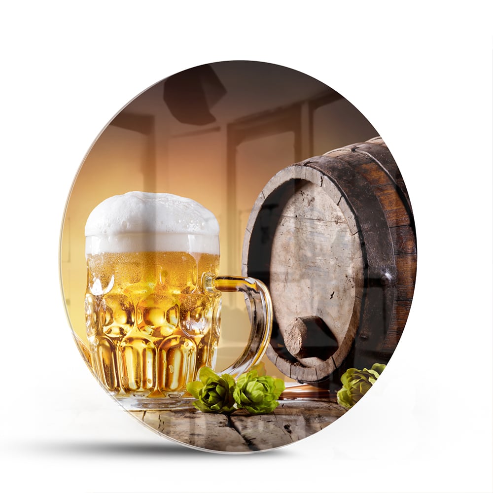 Glazen schilderij van een koud biertje op een houten tafel met groen in de achtergrond.