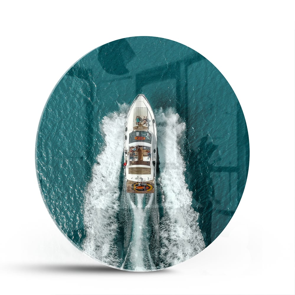 Glazen schilderij van een boot die door turquoise water vaart.