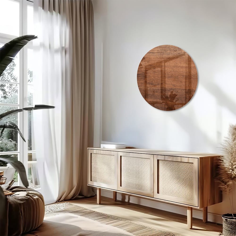 Glazen schilderij in warme houttint hangt boven een moderne kast in een woonkamer.