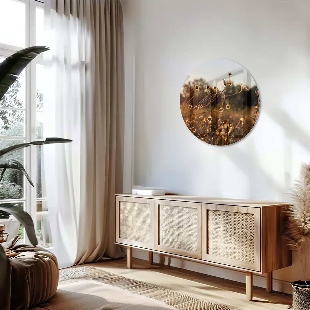 Glazen schilderij van een zonsondergang met bloeiende bloemen, hangend aan een witte muur.