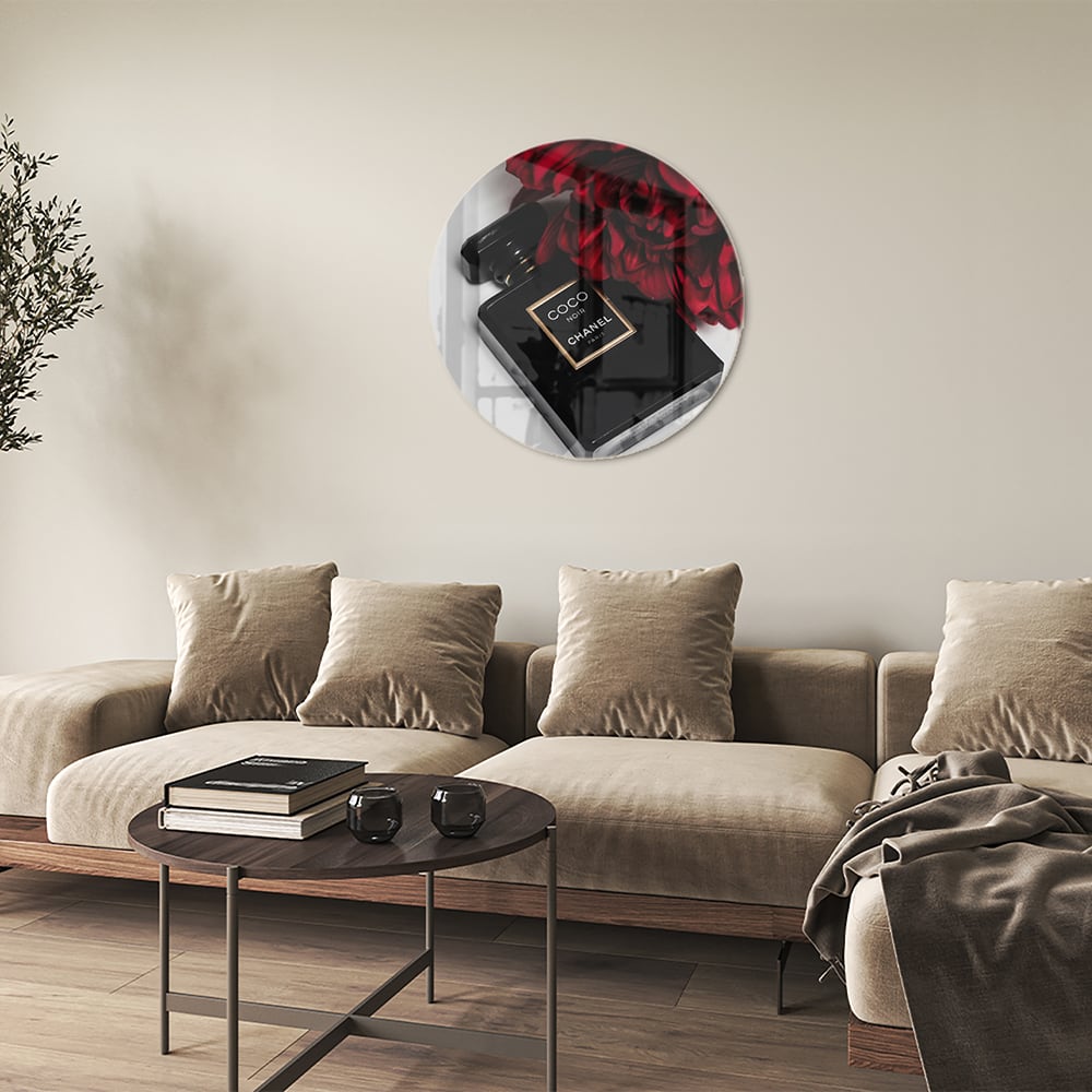 Glazen schilderij van parfumfles met rode bloemen op een witte muur