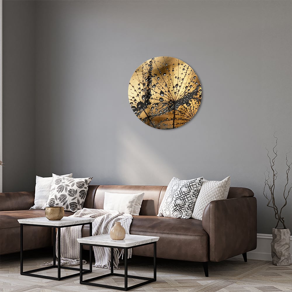 Glazen schilderij met gouden waterdruppels op een lichte muur.