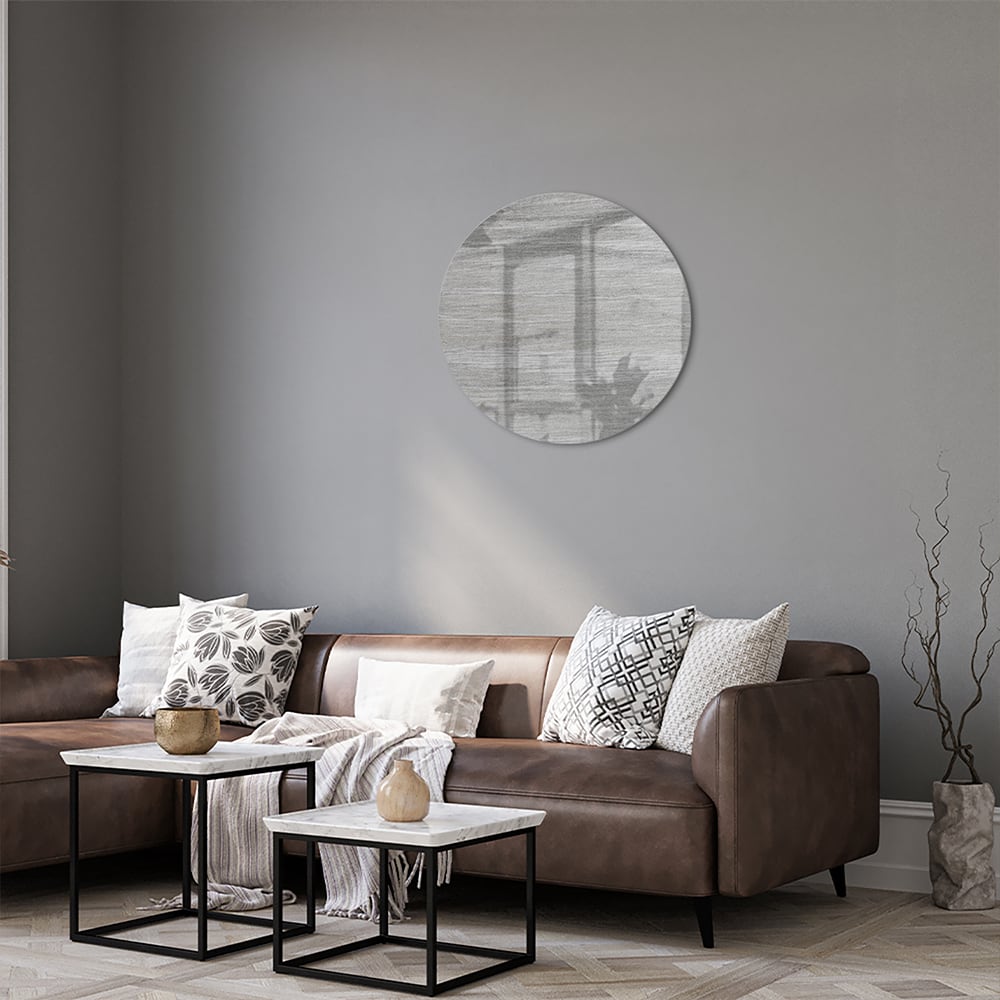 Minimalistisch glazen schilderij met grijstinten aan muur in moderne woonkamer.